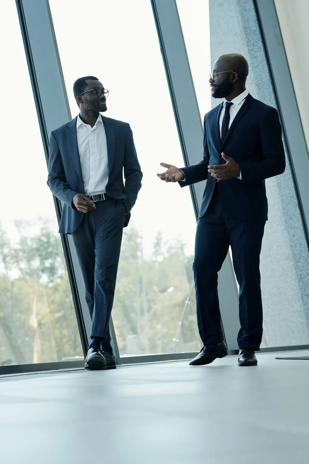 Two KONNY AFRIQUE team members talking in a bright office
